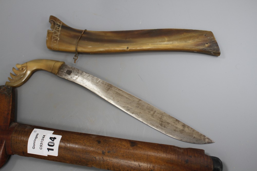 A Kris with hardwood handle and scabbard and another similar with horn scabbard